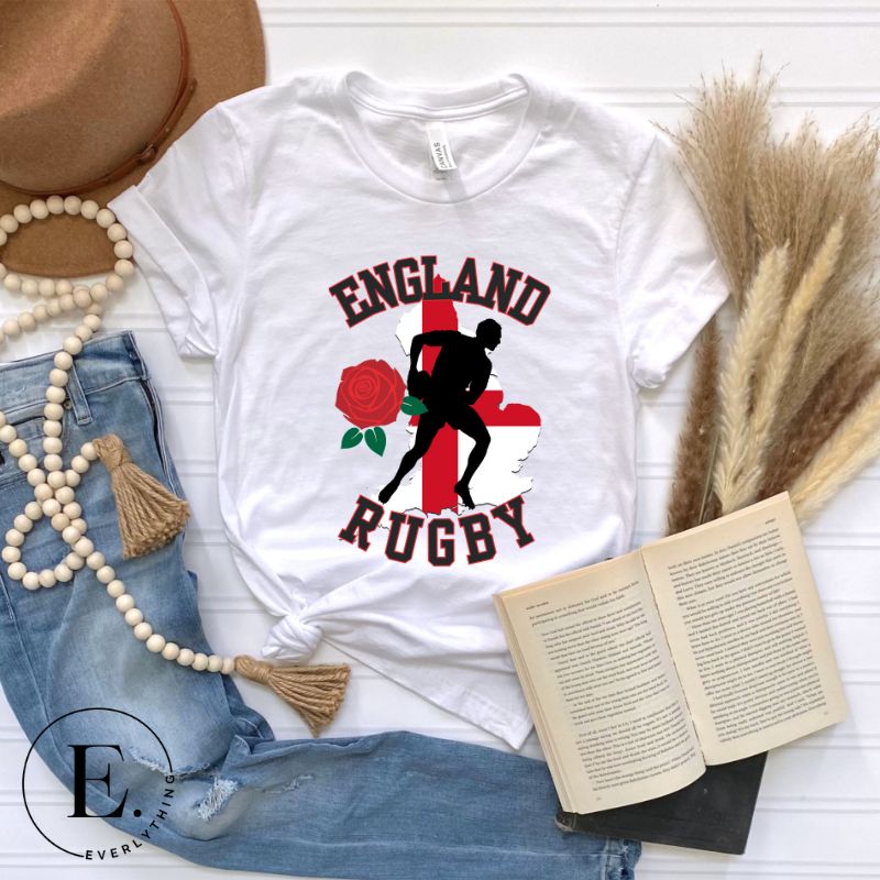 Introducing our England Rugby Graphic T-Shirt - the ultimate fusion of patriotism, rugby pride, and contemporary style! This captivating t-shirt features the words "England Rugby" and the iconic England flag artfully incorporated within the outline of the country, accompanied by a dynamic rugby player graphic on a white shirt. 