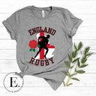 Introducing our England Rugby Graphic T-Shirt - the ultimate fusion of patriotism, rugby pride, and contemporary style! This captivating t-shirt features the words "England Rugby" and the iconic England flag artfully incorporated within the outline of the country, accompanied by a dynamic rugby player graphic on a grey shirt. 