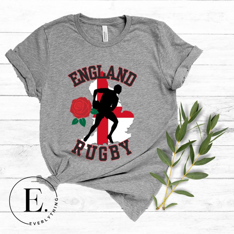 Introducing our England Rugby Graphic T-Shirt - the ultimate fusion of patriotism, rugby pride, and contemporary style! This captivating t-shirt features the words "England Rugby" and the iconic England flag artfully incorporated within the outline of the country, accompanied by a dynamic rugby player graphic on a grey shirt. 