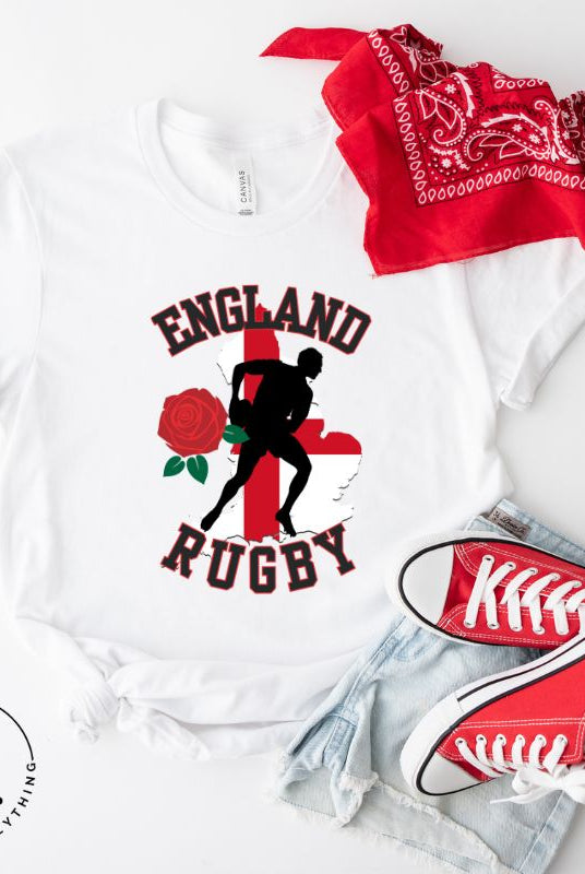Introducing our England Rugby Graphic T-Shirt - the ultimate fusion of patriotism, rugby pride, and contemporary style! This captivating t-shirt features the words "England Rugby" and the iconic England flag artfully incorporated within the outline of the country, accompanied by a dynamic rugby player graphic on a white shirt. 
