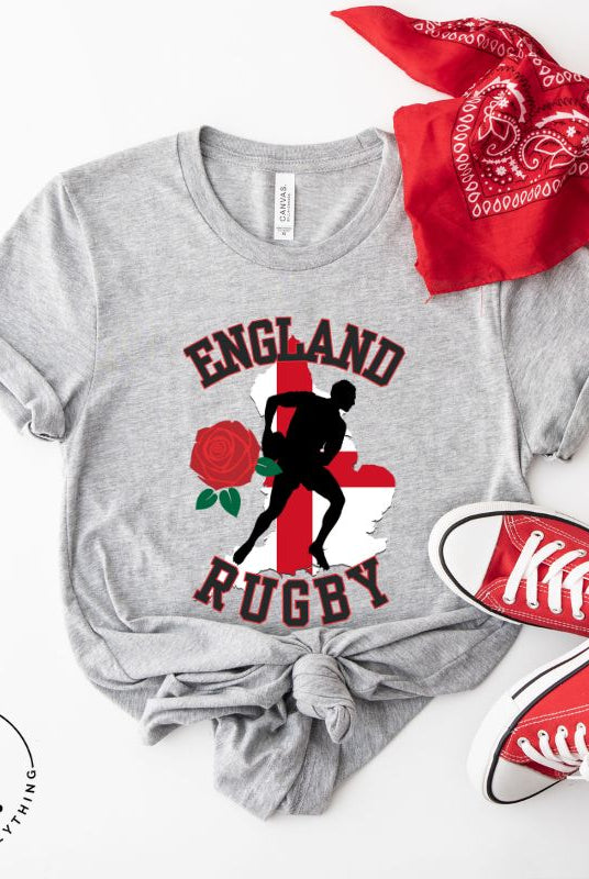 Introducing our England Rugby Graphic T-Shirt - the ultimate fusion of patriotism, rugby pride, and contemporary style! This captivating t-shirt features the words "England Rugby" and the iconic England flag artfully incorporated within the outline of the country, accompanied by a dynamic rugby player graphic on a grey shirt. 