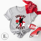 Introducing our England Rugby Graphic T-Shirt - the ultimate fusion of patriotism, rugby pride, and contemporary style! This captivating t-shirt features the words "England Rugby" and the iconic England flag artfully incorporated within the outline of the country, accompanied by a dynamic rugby player graphic on a grey shirt. 