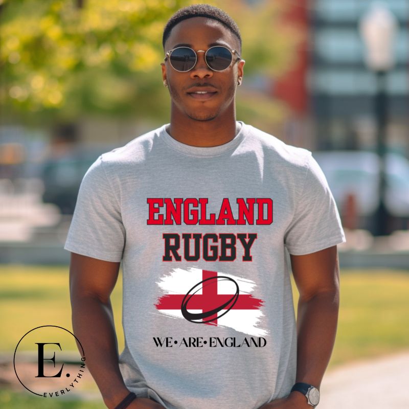Introducing our England Rugby Graphic T-Shirt - a dynamic and spirited way to showcase your unwavering support for the English rugby team! This captivating t-shirt features the words "England Rugby" and the iconic England flag, with the powerful statement "We are England" proudly displayed beneath the flag on a grey shirt. 