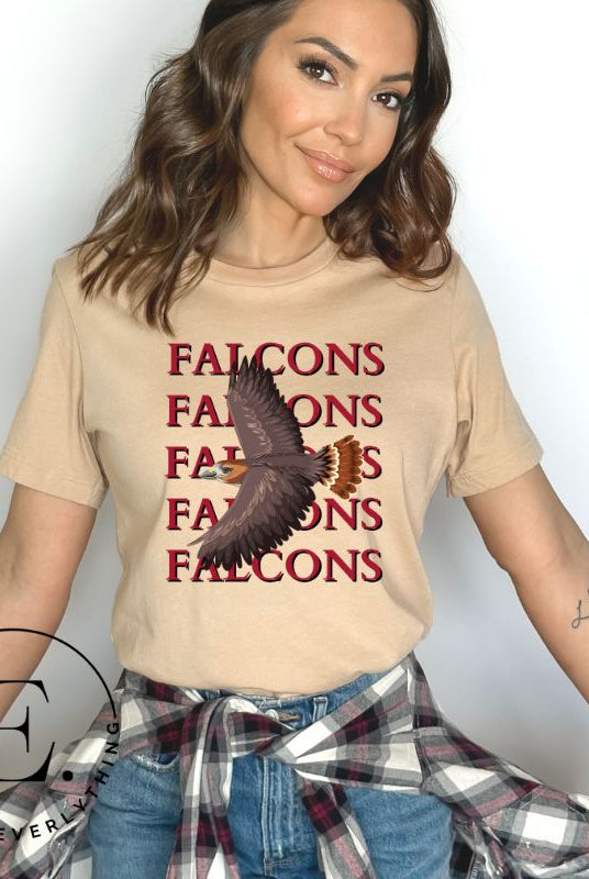 Get ready to soar with style in our Bella Canvas 3001 unisex graphic t-shirt! Featuring a bold Falcon illustration, on a tan shirt. 