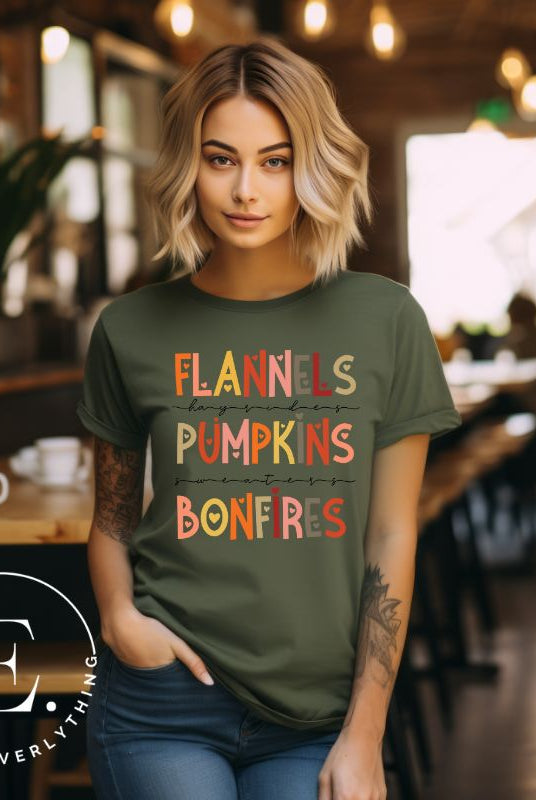 Embrace the cozy spirit of fall with our Flannel, Hayrides, Pumpkins, Sweaters, Bonfires shirt. Featuring the iconic fall elements, this shirt celebrates the season of warmth and comfort on a green shirt. 