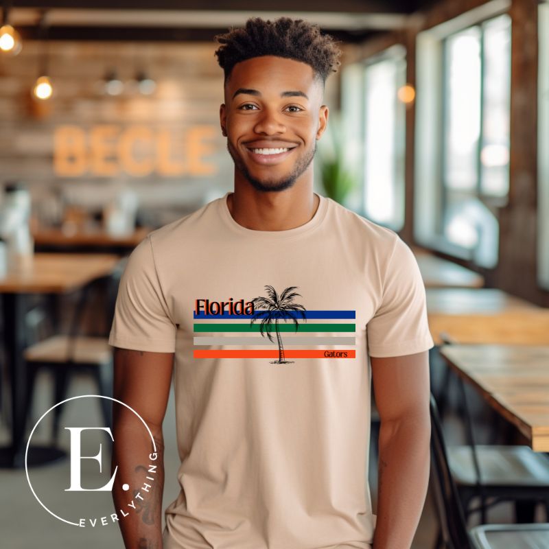 Celebrate your love for the Florida Gators with our modern-inspired retro t-shirt. It captures the essence of campus life, featuring school colors in lines and a palm tree motif on a tan shirt. 