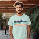 Celebrate your love for the Florida Gators with our modern-inspired retro t-shirt. It captures the essence of campus life, featuring school colors in lines and a palm tree motif on a mint shirt. 
