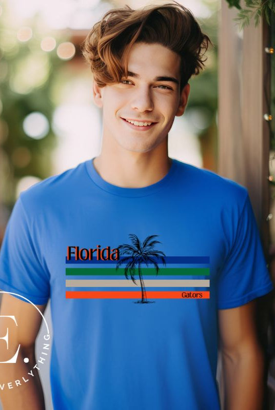Celebrate your love for the Florida Gators with our modern-inspired retro t-shirt. It captures the essence of campus life, featuring school colors in lines and a palm tree motif on a blue shirt. 
