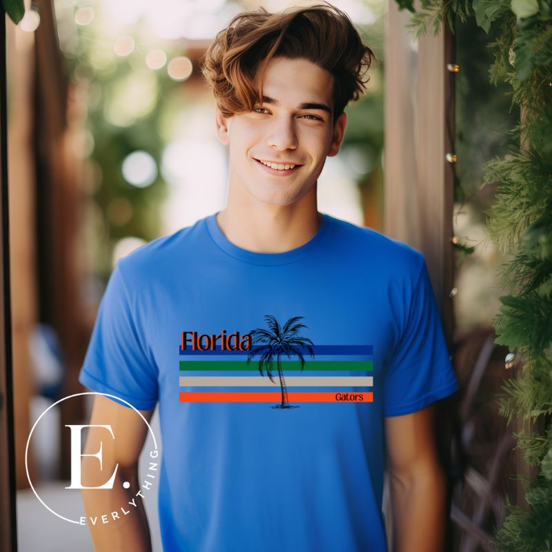Celebrate your love for the Florida Gators with our modern-inspired retro t-shirt. It captures the essence of campus life, featuring school colors in lines and a palm tree motif on a blue shirt. 