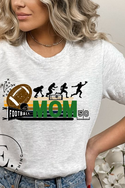 Gear up for game day with our fashionable football mom shirt. Designed for proud moms cheering on their gridiron stars, this shirt is a winning combination of style and comfort. Show off your team spirit and support with pride on a grey shirt. 