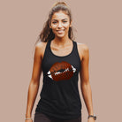 a graphic of lips with football stitching, combining a sporty and chic style, perfect for football enthusiasts on a black tank top