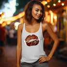 a graphic of lips with football stitching, combining a sporty and chic style, perfect for football enthusiasts on a heather white tank top