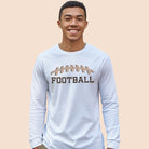 A white long-sleeve shirt featuring a football graphic with cheetah print details and the word "FOOTBALL" in bold, playful lettering. The design is placed prominently on the chest, perfect for sports enthusiasts.