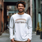 A white long-sleeve shirt featuring a football graphic with cheetah print details and the word "FOOTBALL" in bold, playful lettering. The design is placed prominently on the chest, perfect for sports enthusiasts.