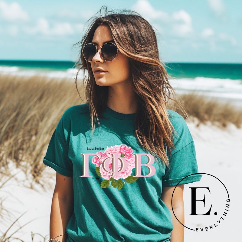 Unleash your Gamma Phi Beta pride with our premium sublimation t-shirt download. Showcasing the sorority's letters and the vibrant pink carnation on a teal shirt. 