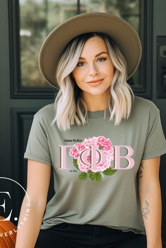 Are you looking for a way to show off your Gamma Phi Beta pride? Look no further than our sorority t-shirt design! Our shirts feature the sorority letters and a beautiful pink carnation, representing the values of sisterhood and beauty that Gamma Phi Beta stands for on an olive shirt. 