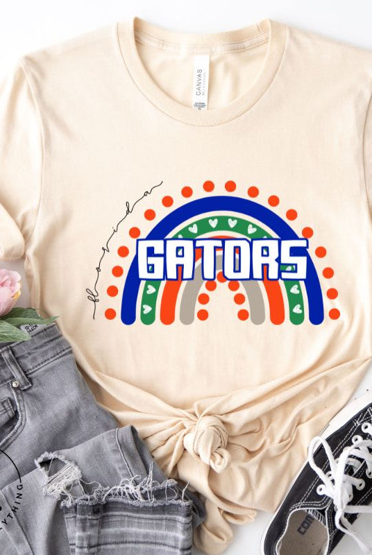 Show off your UF spirit in style with this boho-inspired t-shirt from the University of Florida. The UF colors stands out on this vibrant rainbow background, displaying the school's mascot name in a trendy and unique way on a soft cream shirt. 
