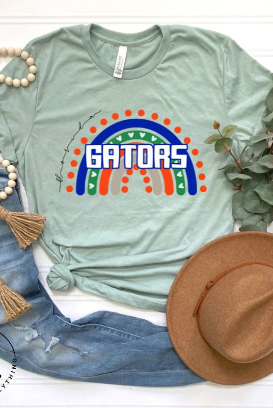 Show off your UF spirit in style with this boho-inspired t-shirt from the University of Florida. The UF colors stands out on this vibrant rainbow background, displaying the school's mascot name in a trendy and unique way on a green shirt. 