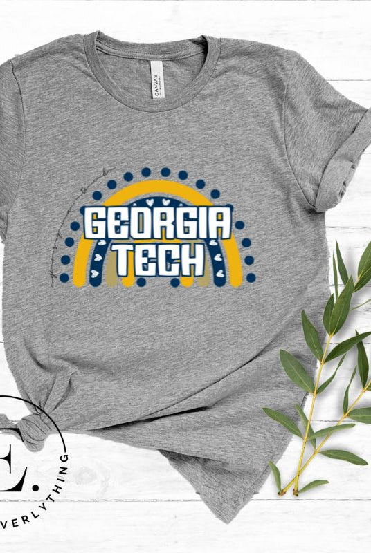 Elevate your Georgia Tech pride with this boho-inspired university t-shirt. The Georgia Tech colors shine through on a vibrant rainbow background, showcasing the school's name in a trendy and unique way on a grey shirt. 