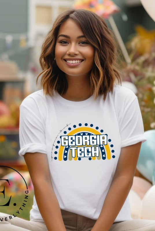 Elevate your Georgia Tech pride with this boho-inspired university t-shirt. The Georgia Tech colors shine through on a vibrant rainbow background, showcasing the school's name in a trendy and unique way on a white shirt. 