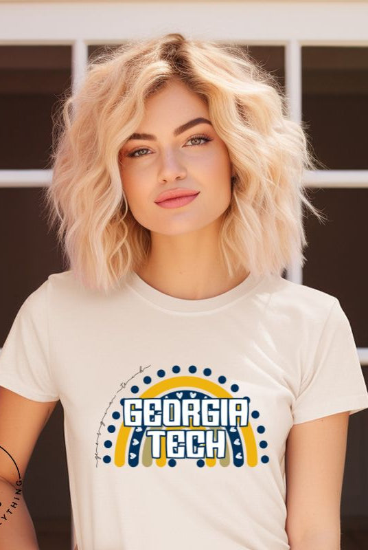 Elevate your Georgia Tech pride with this boho-inspired university t-shirt. The Georgia Tech colors shine through on a vibrant rainbow background, showcasing the school's name in a trendy and unique way on a cream shirt. 