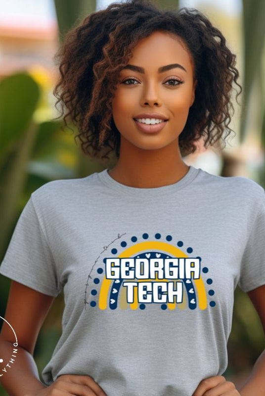 Elevate your Georgia Tech pride with this boho-inspired university t-shirt. The Georgia Tech colors shine through on a vibrant rainbow background, showcasing the school's name in a trendy and unique way on a grey shirt. 