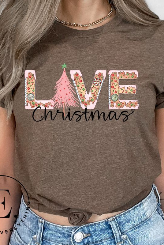 Get ready to celebrate the holiday season in style with our Christmas shirt featuring cute gingerbread cookies arranged to spell out the word "Love" on a brown colored shirt.