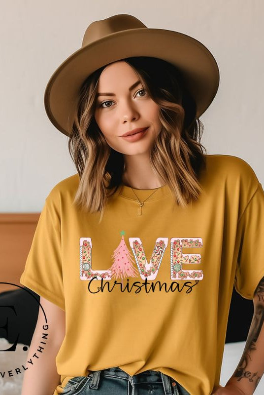 Get ready to celebrate the holiday season in style with our Christmas shirt featuring cute gingerbread cookies arranged to spell out the word "Love" on a mustard colored shirt.