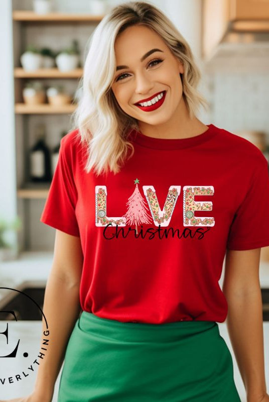 Get ready to celebrate the holiday season in style with our Christmas shirt featuring cute gingerbread cookies arranged to spell out the word "Love" on a red colored shirt.