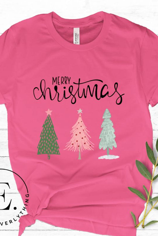 Elevate your festive wardrobe with our trendy shirt and make a chic statement this Christmas. The design features a stylish "Merry Christmas" message along with modern pink and teal Christmas trees, adding a fresh twist to the holiday season on a pink shirt.