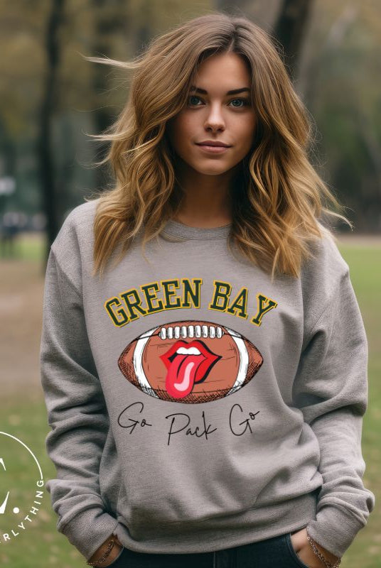 Support the Green Bay Packers in style with our exclusive sweatshirt featuring the team's name and iconic slogan, "Go Pack Go." On a grey sweatshirt.