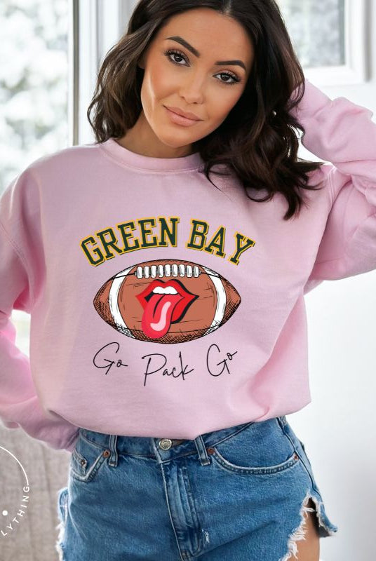 Support the Green Bay Packers in style with our exclusive sweatshirt featuring the team's name and iconic slogan, "Go Pack Go." On a light pink sweatshirt. 