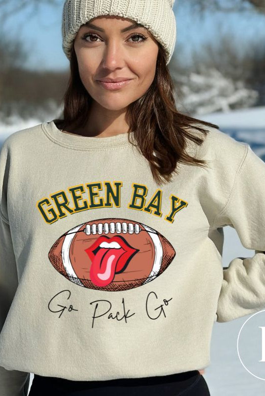 Support the Green Bay Packers in style with our exclusive sweatshirt featuring the team's name and iconic slogan, "Go Pack Go." ON a sand colored sweatshirt. 