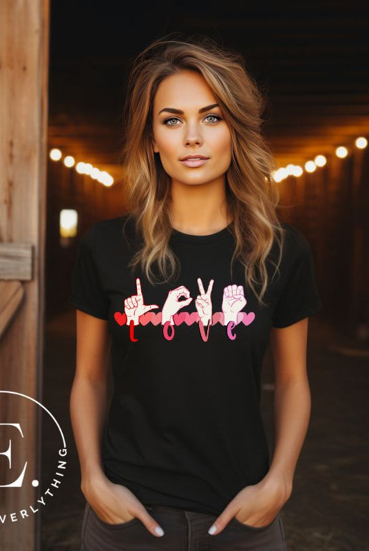 Beautiful ASL hand gesture spelling out love with hearts on a black colored shirt.