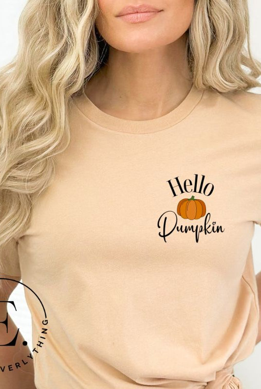 Say hello to autumn with our adorable t-shirt. It features a pumpkin on the front pocket and the playful phrase 'Hello Pumpkin,' this design captures the spirit of the season on a tan shirt. 