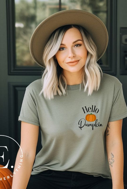Say hello to autumn with our adorable t-shirt. It features a pumpkin on the front pocket and the playful phrase 'Hello Pumpkin,' this design captures the spirit of the season on a green shirt. 
