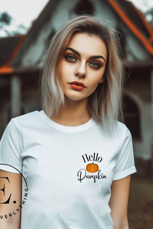 Say hello to autumn with our adorable t-shirt. It features a pumpkin on the front pocket and the playful phrase 'Hello Pumpkin,' this design captures the spirit of the season on a white shirt. 