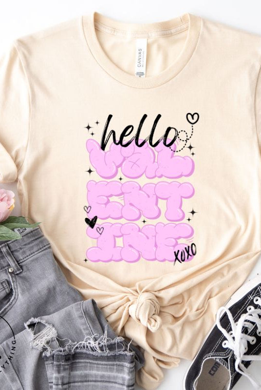 Make a bold statement this Valentine's Day with our street-style graffiti tee! Featuring "Hello Valentine" In eye-catching bubble lettering, on a soft cream shirt. 