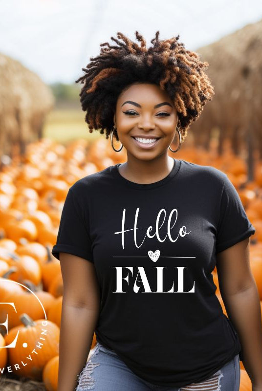 Hello Fall with heart between Hello and Fall graphic tee on a black heather shirt.