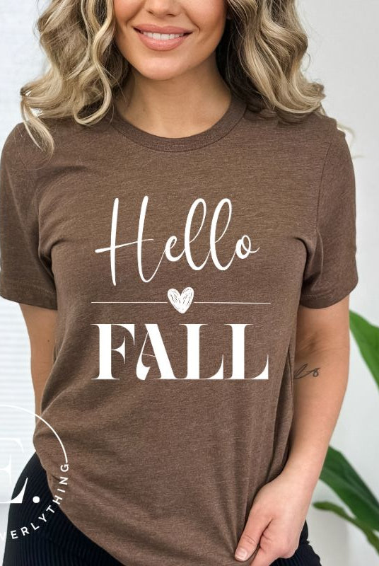 Hello Fall with heart between Hello and Fall graphic tee on a brown colored shirt.