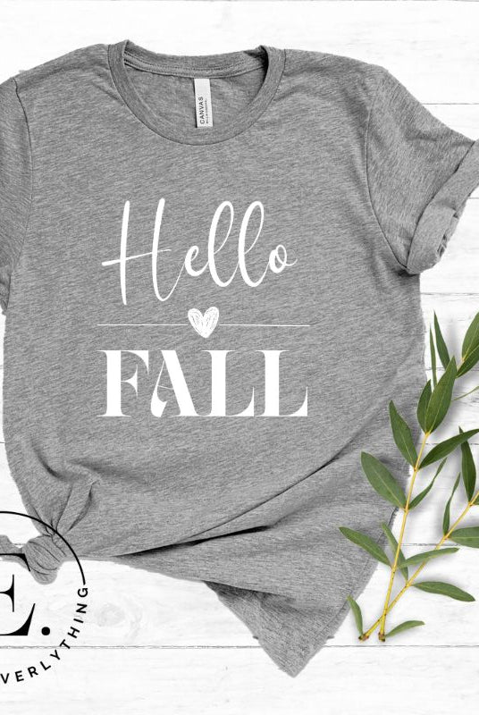 Hello Fall with heart between Hello and Fall graphic tee on a grey colored shirt.
