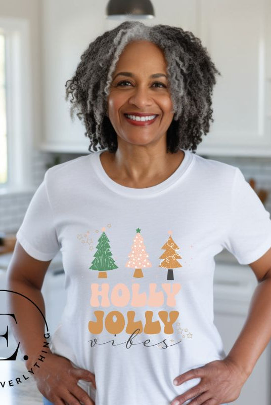 Get ready to feel the holly jolly vibes with our Christmas shirt! This festive shirt features a playful message that reads "Holly Jolly Vibes" and is adorned with cheerful Christmas trees, radiating the holiday cheer on a white shirt