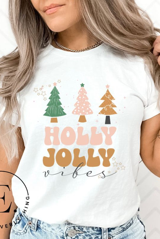 Get ready to feel the holly jolly vibes with our Christmas shirt! This festive shirt features a playful message that reads "Holly Jolly Vibes" and is adorned with cheerful Christmas trees, radiating the holiday cheer on a white shirt
