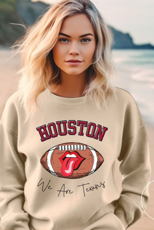 Embrace your Houston Texans pride with our exclusive sweatshirt. It features the team's name and an empowering slogan, "We Are Texans." On a sand colored sweatshirt. 
