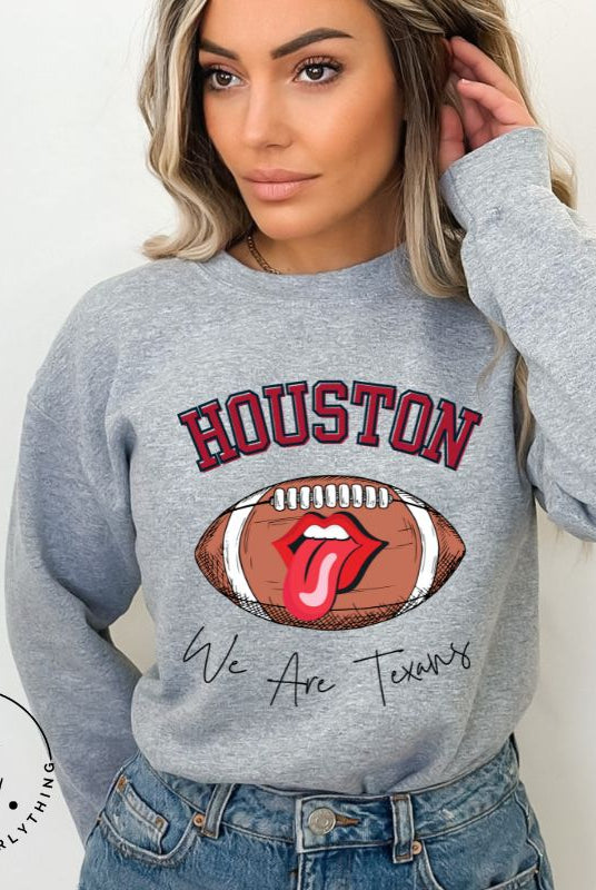 Embrace your Houston Texans pride with our exclusive sweatshirt. It features the team's name and an empowering slogan, "We Are Texans." On a grey sweatshirt. 