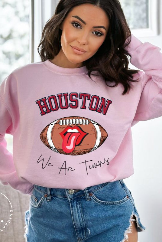 Embrace your Houston Texans pride with our exclusive sweatshirt. It features the team's name and an empowering slogan, "We Are Texans." On a pink sweatshirt. 