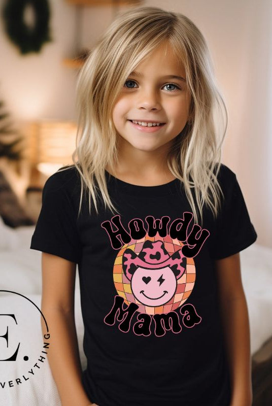 Yeehaw! Get ready to ride into style with our kids' shirt featuring a checkered ball with a winking smiley face, a lightning bolt, and a cowboy hat. With the playful saying 'Howdy Mama,' it's a fun and expressive choice on a black shirt. 