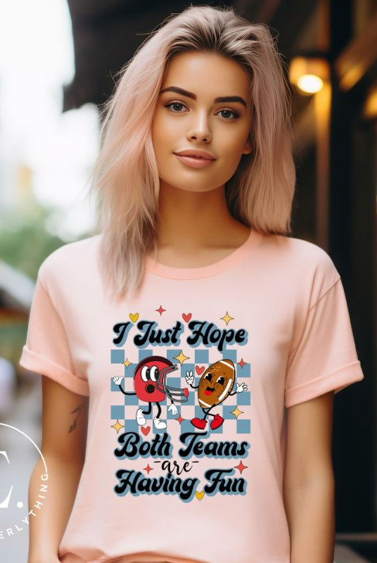 Dress in game day spirit with our Bella Canvas 3001 unisex tee! Featuring a retro design and the fun mantra, "I just hope both teams are having fun," on prism peach shirt. 