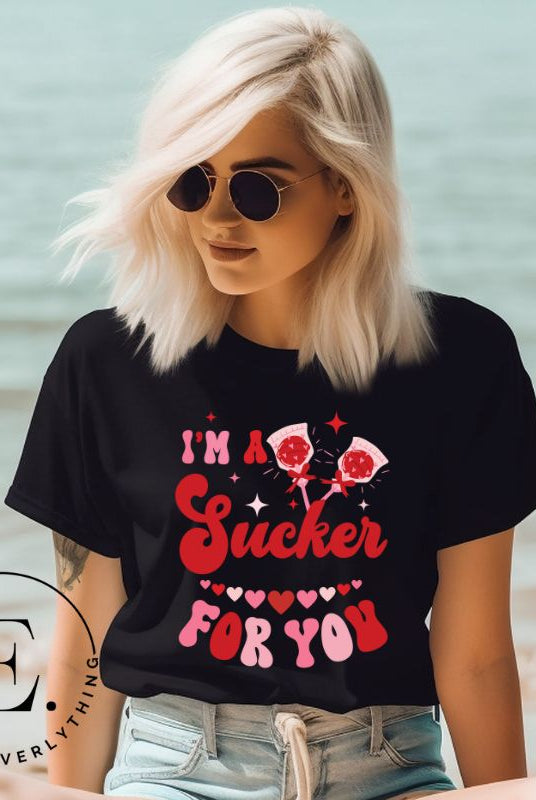 Indulge in the spirit of love with our Valentine's Day shirt! Adorned with charming Valentine lollipops and the playful saying, "I'm a sucker for you," on a black shirt. 