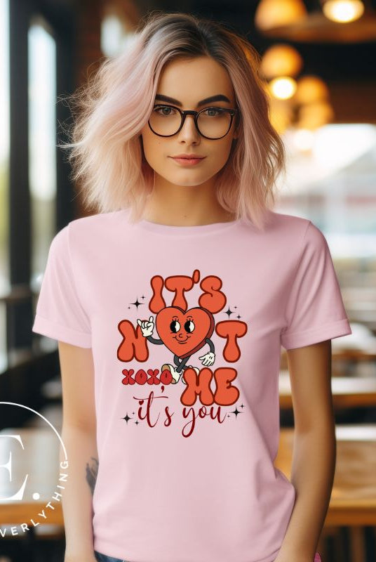 Celebrate Valentine's with our playful shirt! Featuring a bold heart and the message "It's not me, it's you," on a pink shirt. 